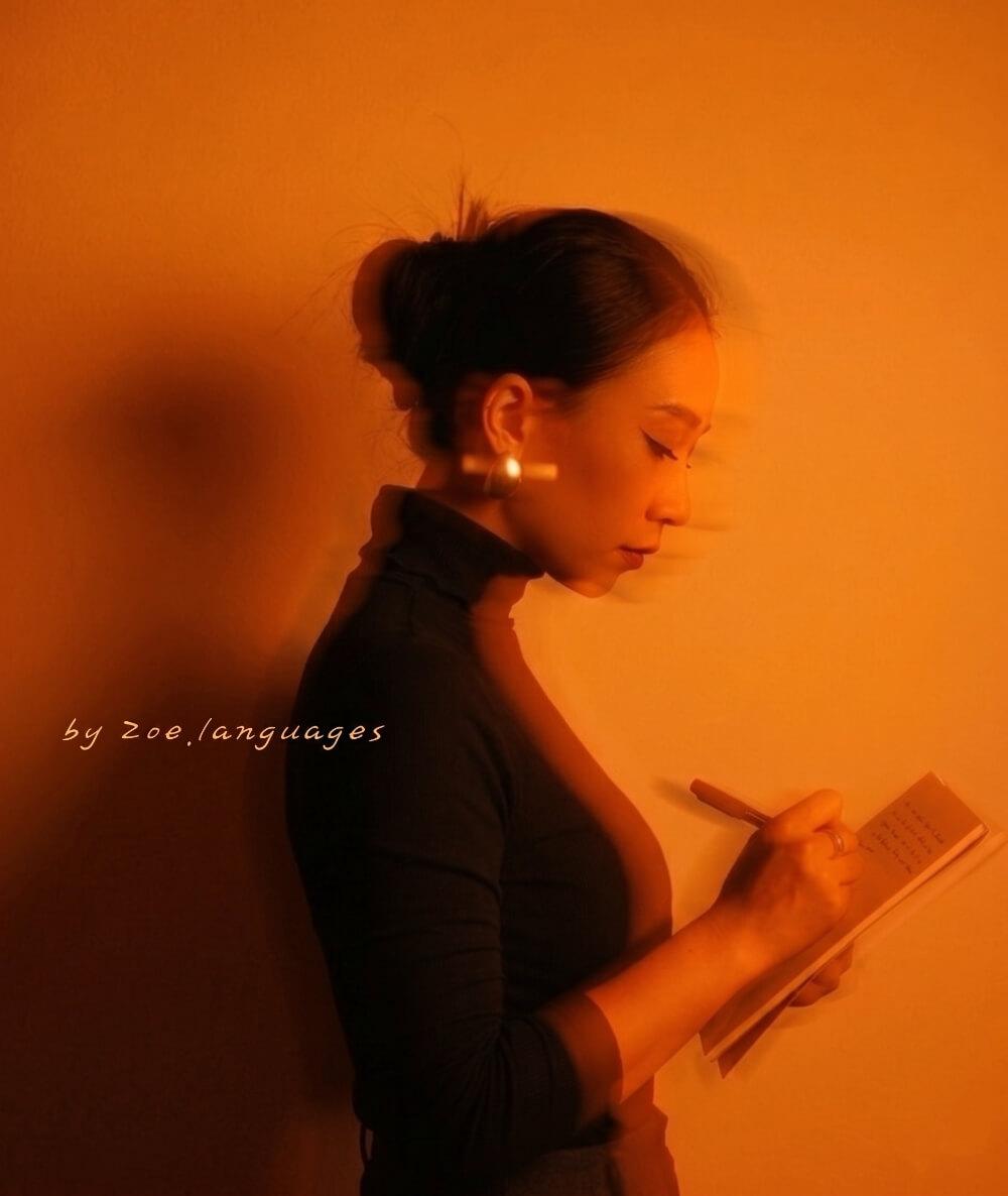 Zoe writing in a notebook — The Language Mind Newsletter